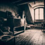 Attic - grayscale photo of wooden chair near window