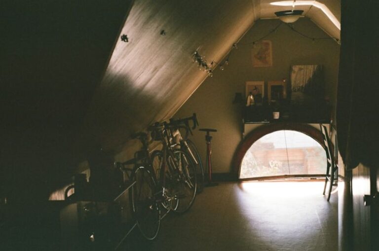 Attic Home - black bicycle near brown wooden cabinet