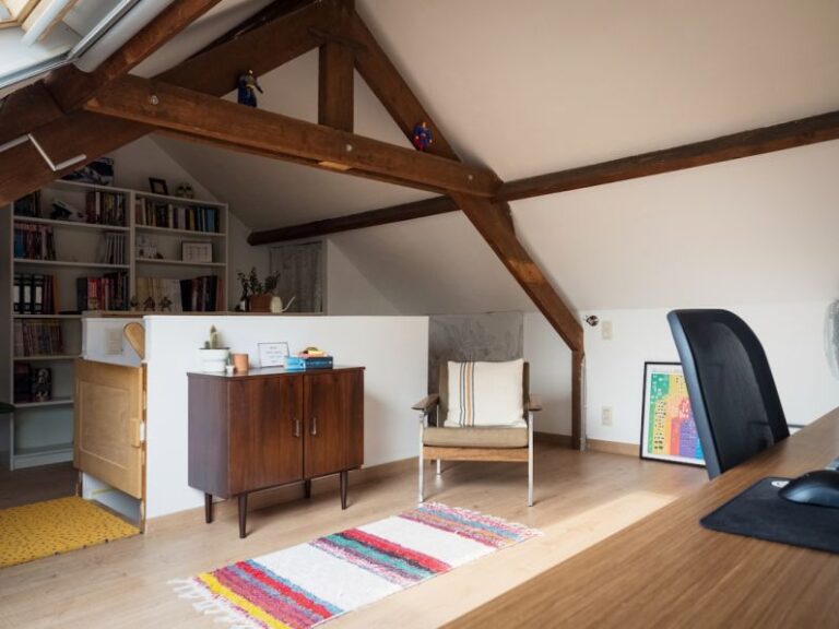 Attic Home - a living room with a chair and a book shelf