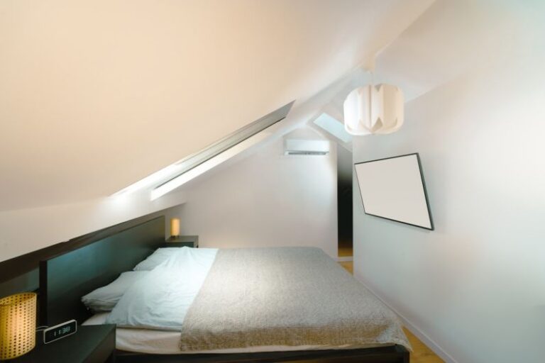 Attic Home - A bed in a room with a slanted ceiling