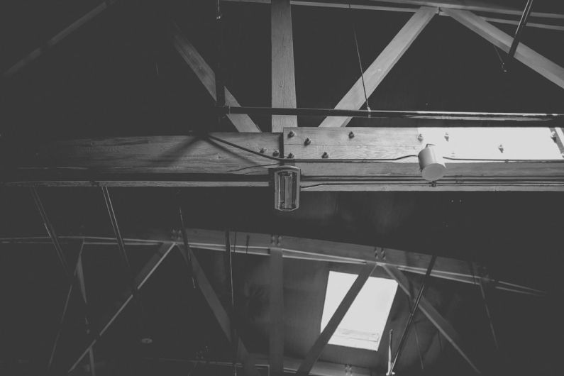 Attic Home - a black and white photo of a metal beam