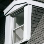 Attic Home - From below exterior fragment of aged residential house with brick walls and attic window in city