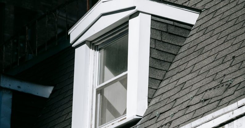 Attic Home - From below exterior fragment of aged residential house with brick walls and attic window in city