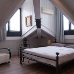 Attic Window - black steel bed frame near window