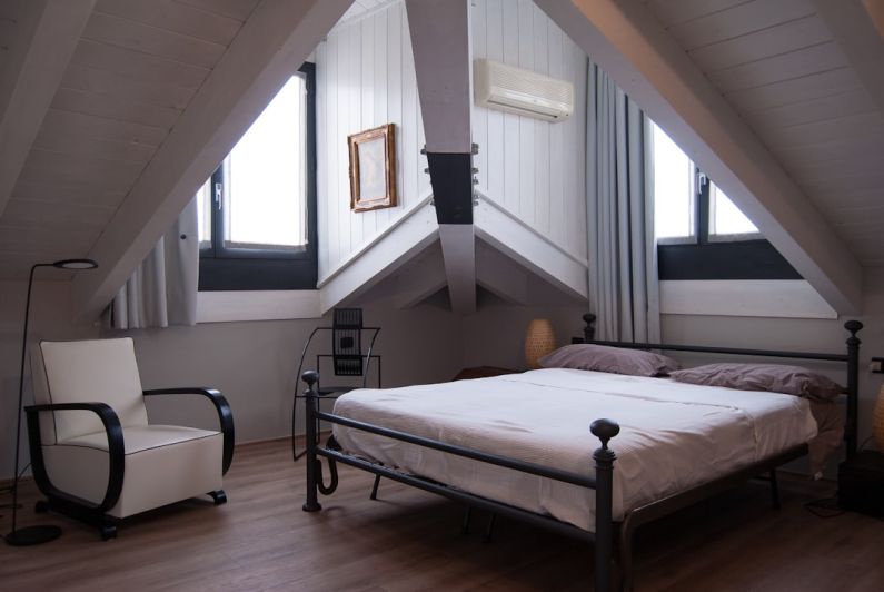 Attic Window - black steel bed frame near window