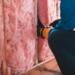 Insulation - person in blue pants sitting on brown wooden floor