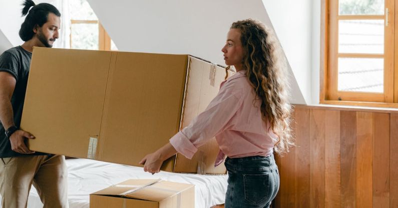 Attic Home - Focused diverse couple relocating in new house