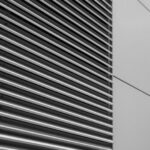 Vent System - a black and white photo of the side of a building