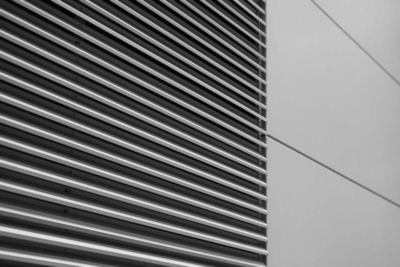 Vent System - a black and white photo of the side of a building