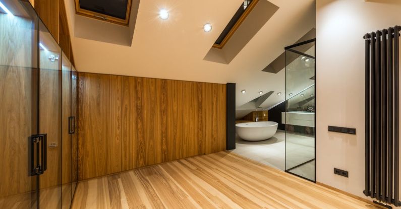 Attic Home - Creative design of bathroom with bath on floor under windows illuminated by lamps in house