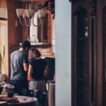 Attic Home - man and woman standing in front of gas range