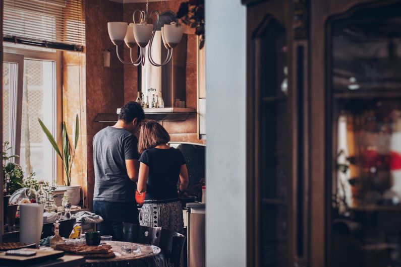 Attic Home - man and woman standing in front of gas range