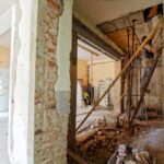 Attic Renovation - man climbing on ladder inside room