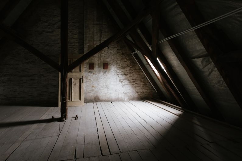 Attic Window - a wooden walkway with a light at the end