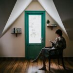 Attic Floor - woman sitting on a chair inside white painted room