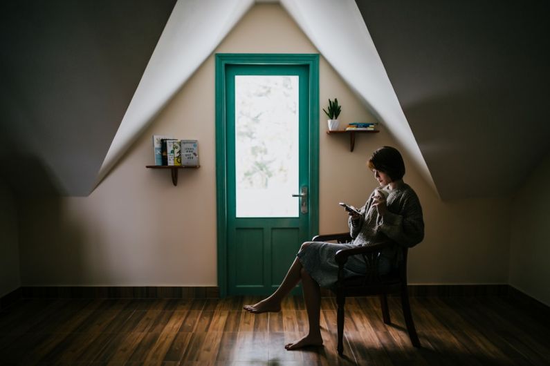 Attic Floor - woman sitting on a chair inside white painted room