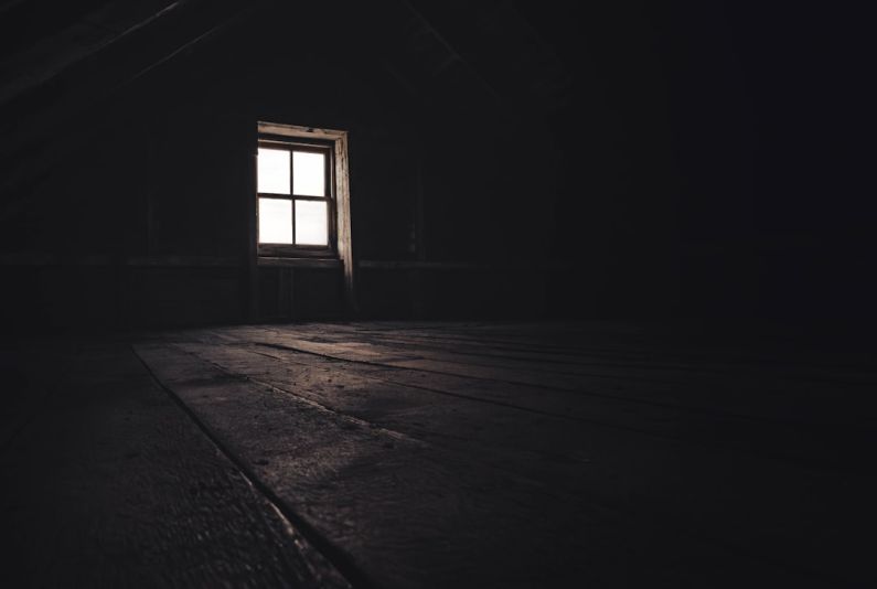 Attic Window - a dark room with a window and a wooden floor