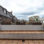 Attic Floor - Veranda with potted plants under cloudy sky