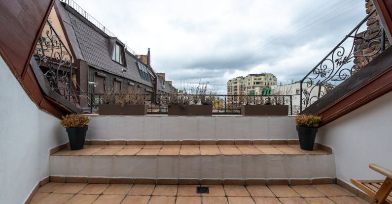 Attic Floor - Veranda with potted plants under cloudy sky