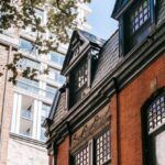 Attic Window - Old building facades against tree in city