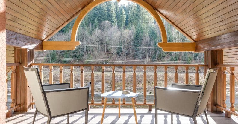 Attic Zones - Wooden Balcony on Attic with Steel Framed Chairs