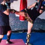 Attic Gym - Two men kick a kick in a boxing ring