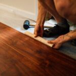 Laminate Flooring - Crop man installing laminate flooring