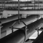 Condensation - Black and white photo of pipes in a room