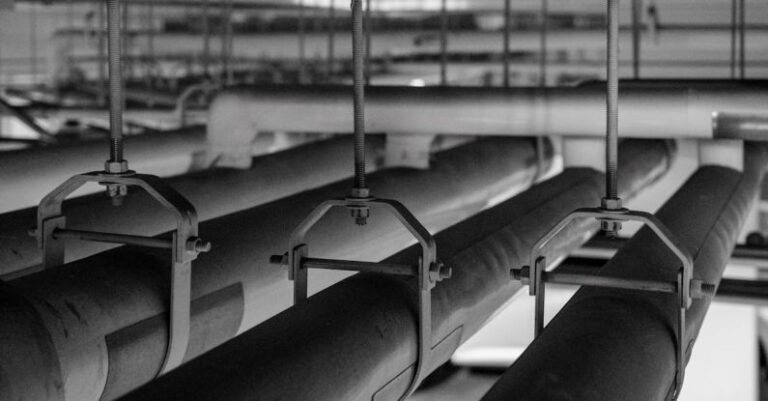 Condensation - Black and white photo of pipes in a room